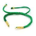 Close-up of handmade green woven cord bracelet with gold bead accents and adjustable strap - Green