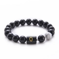 Black agate and white turquoise beaded bracelet featuring a golden letter O charm - Letter O