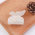 Iridescent white butterfly hair claw clip with pearl luster on a wooden tray - Butterfly / AB White