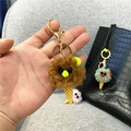 Close-up detail of a cute brown plush ice cream cone keychain with gold hardware - Single Piece / Brown