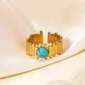 Detail of 18K gold-plated titanium ring with green turquoise on beige silk fabric - Turquoise Stone Style (R0852)