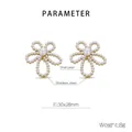 Macro view of flower earrings showing shell pearl inlays and stainless steel petals - Gold Style (KE113294-HM)