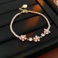 Macro detail of gold flower bracelet with pink and white crystals on black leather - 12# Zirconia Flower Square Bracelet
