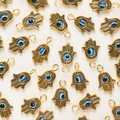Golden Hamsa hand pendants with blue evil eye charms for DIY jewelry making - Antique Gold