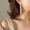 Minimalist long drop earrings with eight brushed silver metal discs in a geometric design - Steel