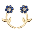 Close-up of S925 silver flower stud earrings with blue and white gems and gold stems - Blue