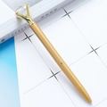 Elegant gold metal ballpoint pen with a large diamond crystal top on a white book - Hanging Chain Gold (Gold Parts)