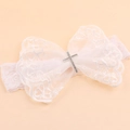White lace baby headband featuring a large bow with a sparkling silver rhinestone cross - Cross Style