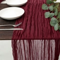 Elegant wine red cheesecloth table runner with natural pleated texture on wooden table - Burgundy