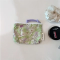 Macro detail of green floral cotton coin purse with white zipper and purple cord handle - Light Green Tiny White Flowers