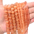 Macro shot of orange cat eye stone beads in various sizes for DIY jewelry making - Dark Champagne