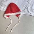 Detail of plush knitted earflap hat with contrast red and cream fluffy faux fur texture - 3-6 Years / Red