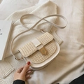 Creamy white woven straw crossbody saddle bag with golden metal clasp and leather strap - White