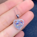Macro close-up showing the sparkling heart pendant held by fingers for scale - 3-carat Heart Necklace Xl-53 [with Cross Chain]