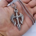 Handheld view of a silver trident pendant necklace with vintage textures and bead chain - Trident