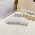 Elegant white acetate hair claw clip in large size for women on beige textured fabric - White
