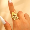 Adjustable gold flower leaf ring with intricate hollow engraving shown on finger - Gold (S365)