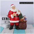 Resin Santa Claus statue with a gift bag full of toys on a blue striped base - Standing Santa With Left Bag