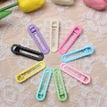 Detailed arrangement of wave-shaped macaron hair clips on beige lace with tulips - Multicolor