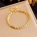 Gold-plated stainless steel woven chain bracelet with a heart pendant on a metal stand - Golden Phoenix Tail Chain Heart Bracelet (B1251)