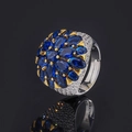 Anello a fiore blu reale con griffe dorate e pavé di cristalli su fondo scuro - Aperto Regolabile / Blu