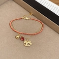 Close-up of a double-layer bracelet with golden horse charm, red gem, and woven cord - 2# Double Layer Bracelet (Gold Chain & Red String) - Gold Pony and Red Gem Pendant