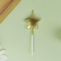 Golden star shaped birthday party candle with white stick on a fresh minimal background - Pentagram / Gold