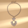Close-up of a luxury silver drop pendant necklace with sparkling zircon and lobster clasp - Silver