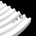 Detailed close-up of silver geometric hoop earrings with unique petal shaped backings - Circle
