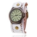 Detail view of white leather strap with rivets and bronze roman numeral dial on a vintage watch - White