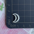 Detail shot of white pearl moon charm showing 2cm size on a blue measuring grid - Moon