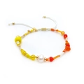 Macro detail of handmade colorful beads with a natural freshwater pearl and adjustable cord - Warm Red Orange Yellow Mix-BLS230040F