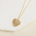 Macro detail of gold-plated hollow heart pendant with sparkling white cubic zirconia - White Zircon Heart Necklace-Hollow Grid Sweet Style