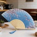 Blue gradient silk folding fan with pink cherry blossoms and bamboo hollow ribs - Style 66 (New Style)