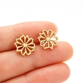 Minimalist gold hollow flower stud earrings in stainless steel held in hand - Radiating Flower / Gold