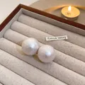Macro detail of silk-texture white pearl earrings in a premium wooden jewelry box - Large (1.8cm) / White