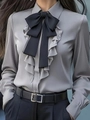 Detail of grey satin shirt featuring layered ruffles and a black ribbon bow tie - S / Gray