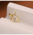 Dettaglio dell'anello a mulino a vento dorato con zirconi e motivo a stella e girasole - Fiore Stellato Rotante / Oro