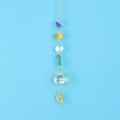 Detailed view of crystal suncatcher with golden sun moon charms and green gemstones - Green Aventurine