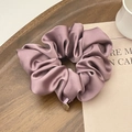 Elegant purple-pink satin scrunchie with pleated texture and golden metal tag charm - Purple
