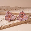 Macro shot of pink crystal flower earrings with silver edges on a beige stone - Silver Earring Post Style / Pink
