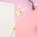 Cartoon daisy gel pen with yellow antlers and sparkling sequins on a pink background - Yellow Deer Daisy