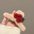Detailed close-up of a large plush cherry hair claw clip featuring red pom-poms and green leaves - Plush Ball Claw Clip / Red