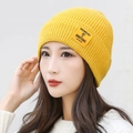 Knitted beanie in bright ginger yellow featuring a MOMENT OF AMBITIONS fabric label - Yellow