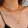 Layered gold necklace featuring thick chains and heart pendant on a female model - Gold 3-Layer Heart Pendant Chain Set (WG-0293)