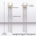 Boucles d'oreilles en acier doré 18k avec perles de nacre et longues franges - Couleur Acier