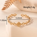 Bracciale rigido aperto regolabile in acciaio inossidabile dorato traforato - Geometrico