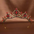 Detailed close-up of Baroque gold crown with red crystals and black rhinestones on silk - Black Red