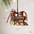 Vintage red Christmas train ornament with golden accents and green wreath decoration - Retro Train Engine
