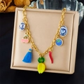 Detailed view of colorful enamel vegetable and fruit charms on a gold tassel necklace - Cherry Banana Chili Tassel Style (N3505)